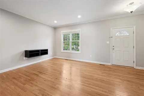 a view of empty room with wooden floor