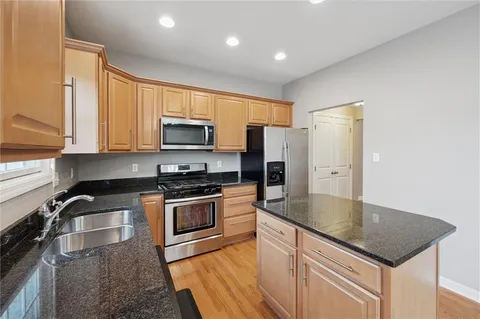 an entryway with wooden floor and chandelier