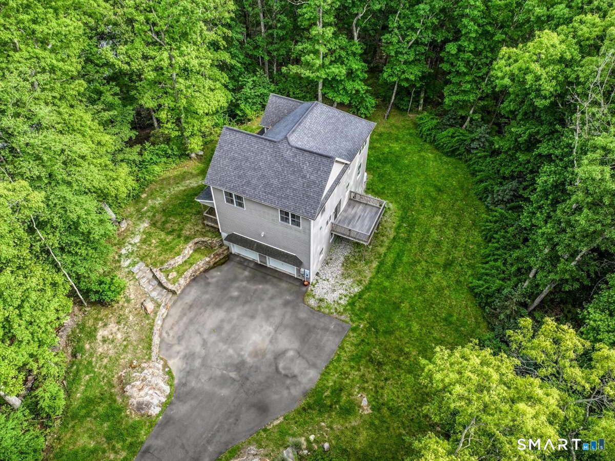 127 Putnam Park Road Bethel, CT 06801 - Photo 27 of 35 a view of a house with a yard and a sitting area