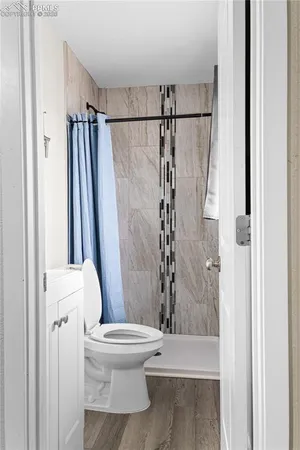 a bathroom with a toilet and a shower