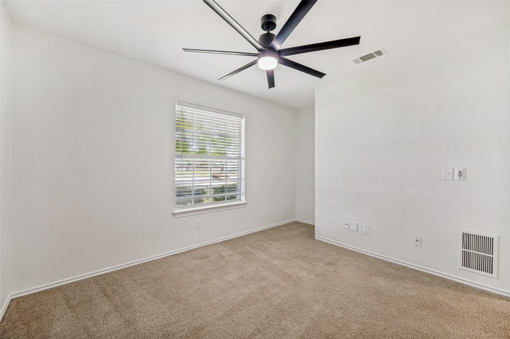 629 Concho Drive Oak Point, TX 75068 - Photo 24 of 35 an empty room with a window and a fan