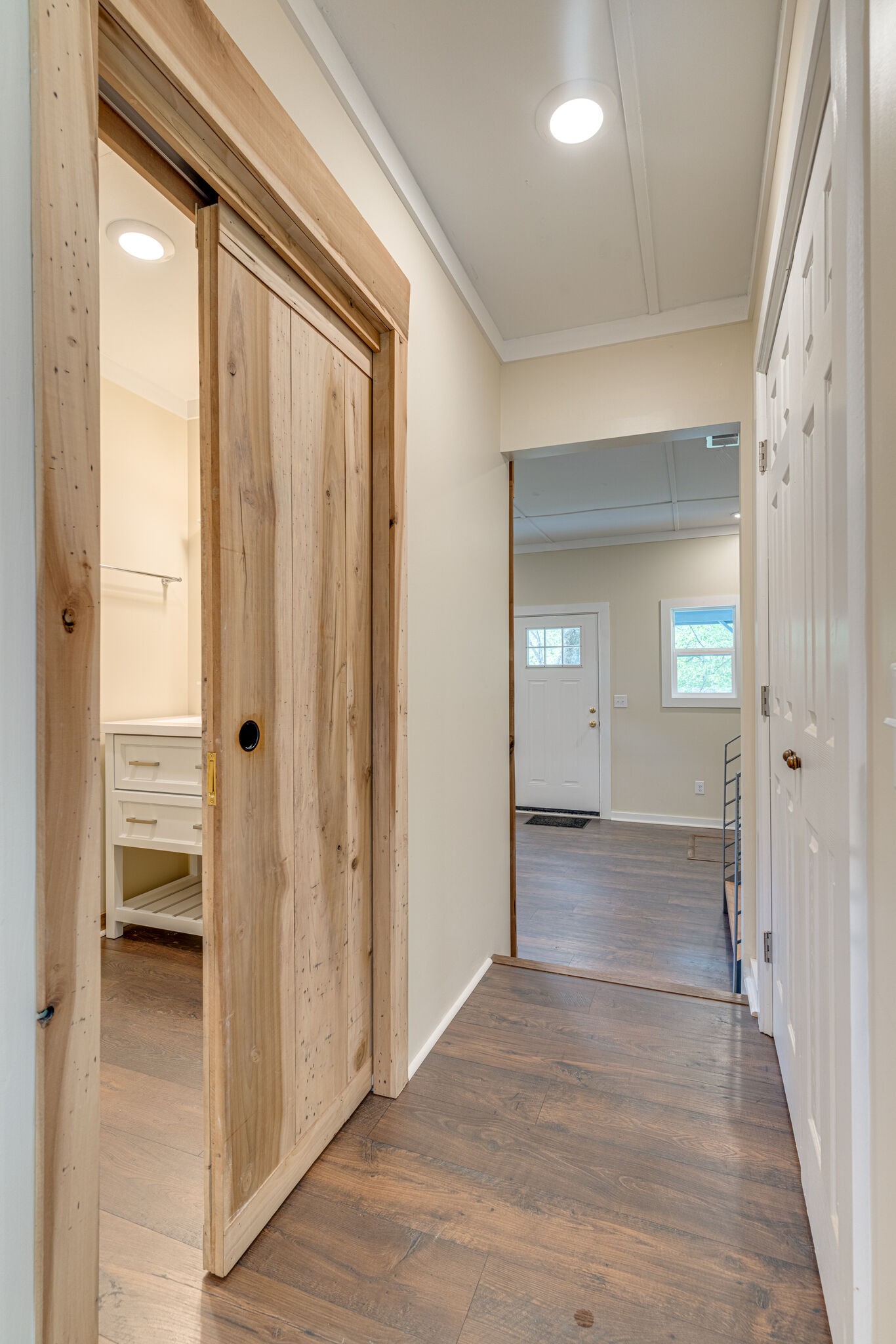 7357 Peaceful Acres Road Greenbrier, TN 37073 - Photo 13 of 27 a view of a hallway with wooden floor and a bathroom