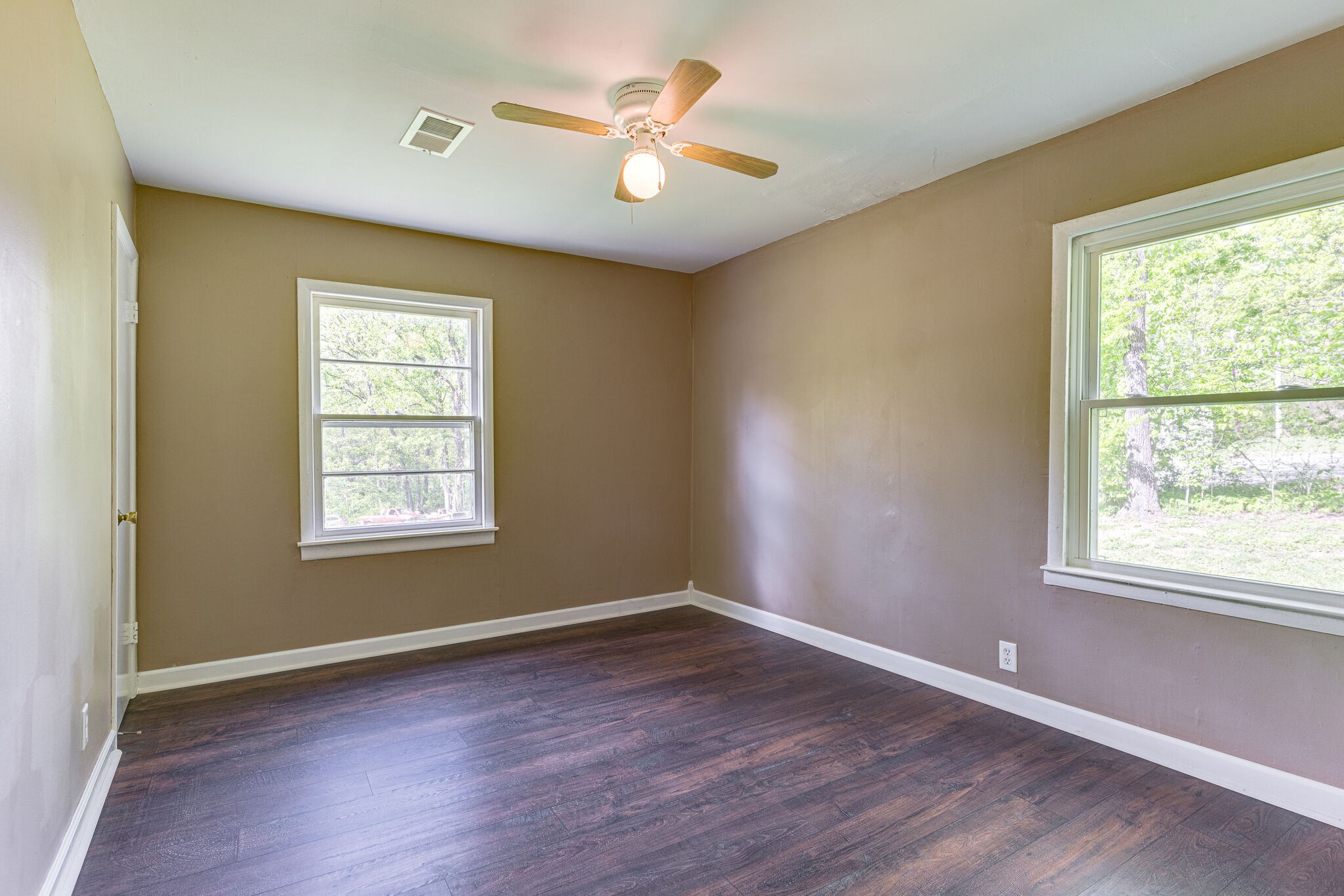 7357 Peaceful Acres Road Greenbrier, TN 37073 - Photo 23 of 27 an empty room with wooden floor and windows
