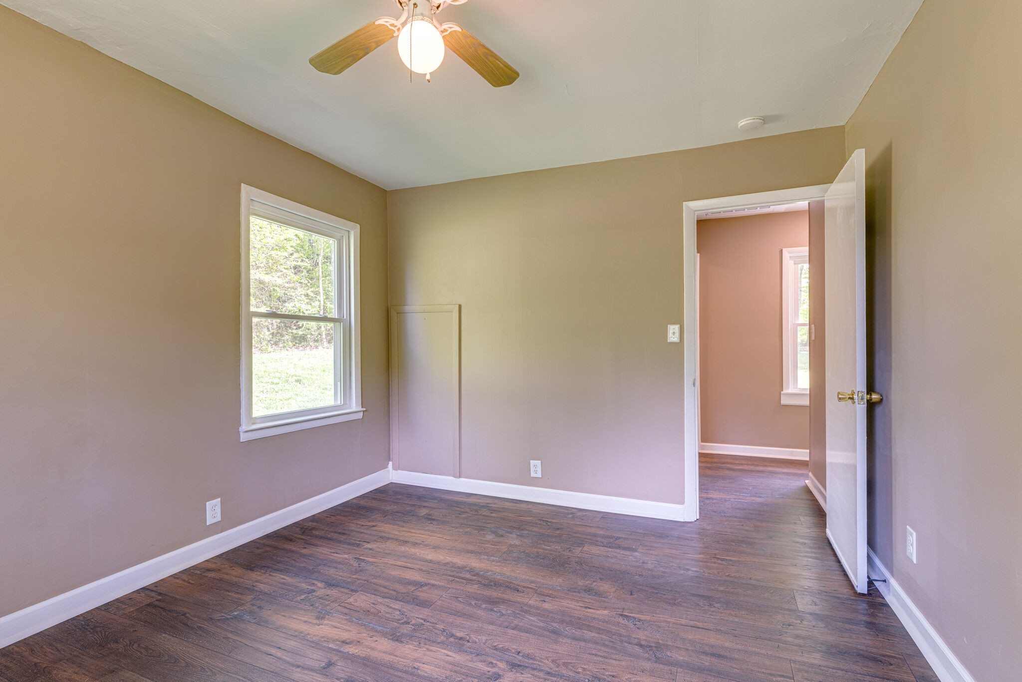 7357 Peaceful Acres Road Greenbrier, TN 37073 - Photo 24 of 27 a view of an empty room with wooden floor and a window