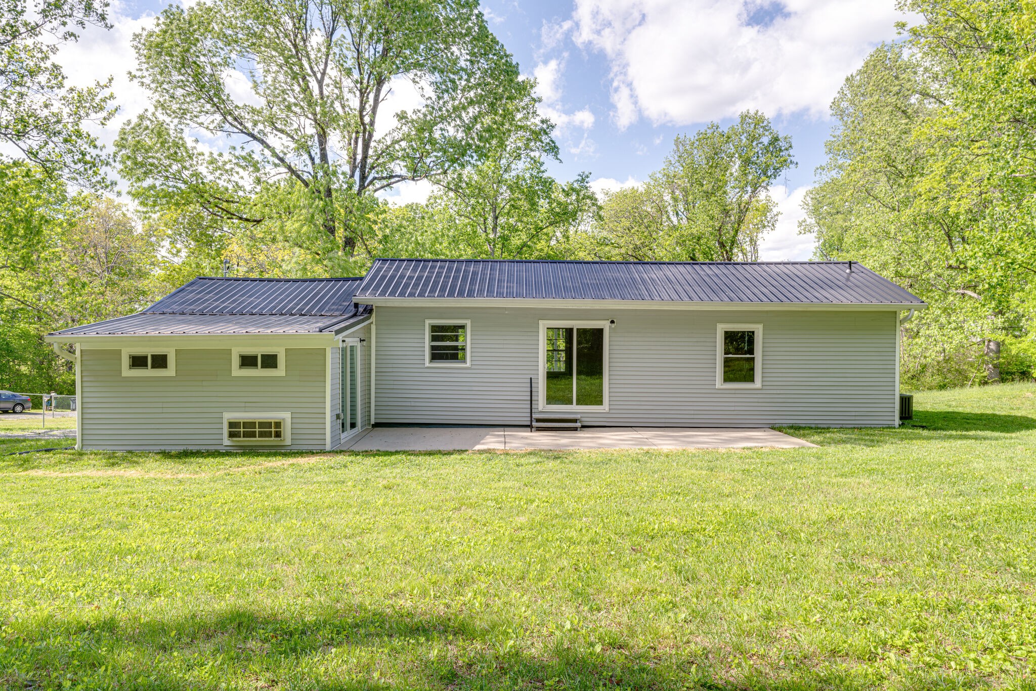 7357 Peaceful Acres Road Greenbrier, TN 37073 - Photo 26 of 27 a view of a house with a big yard and large trees