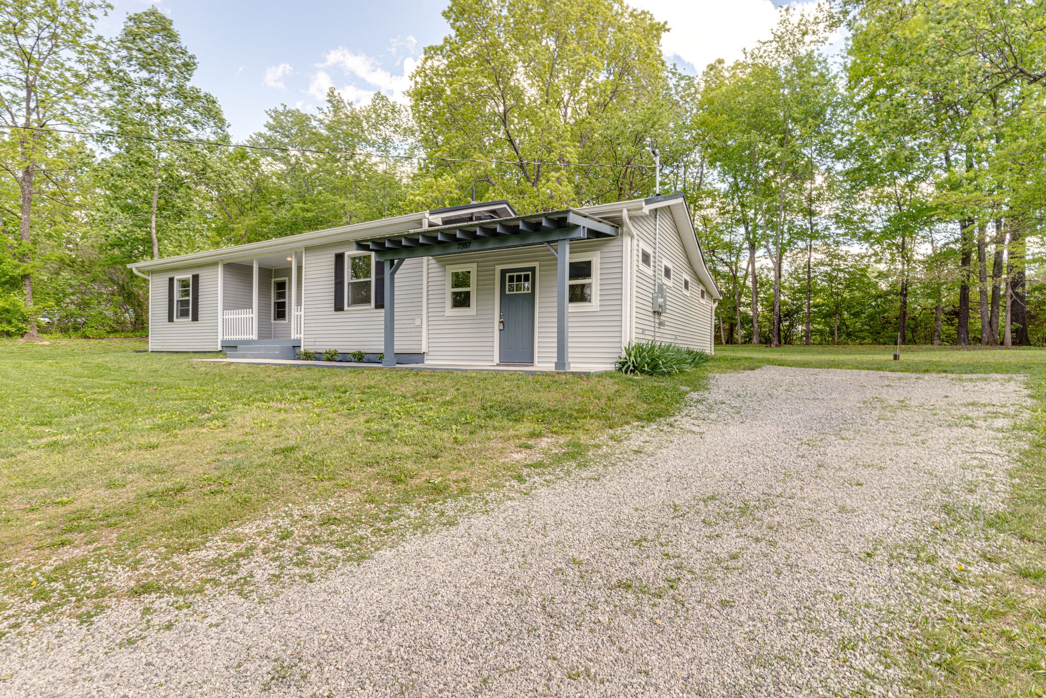 7357 Peaceful Acres Road Greenbrier, TN 37073 - Photo 3 of 27 a house with trees in the background