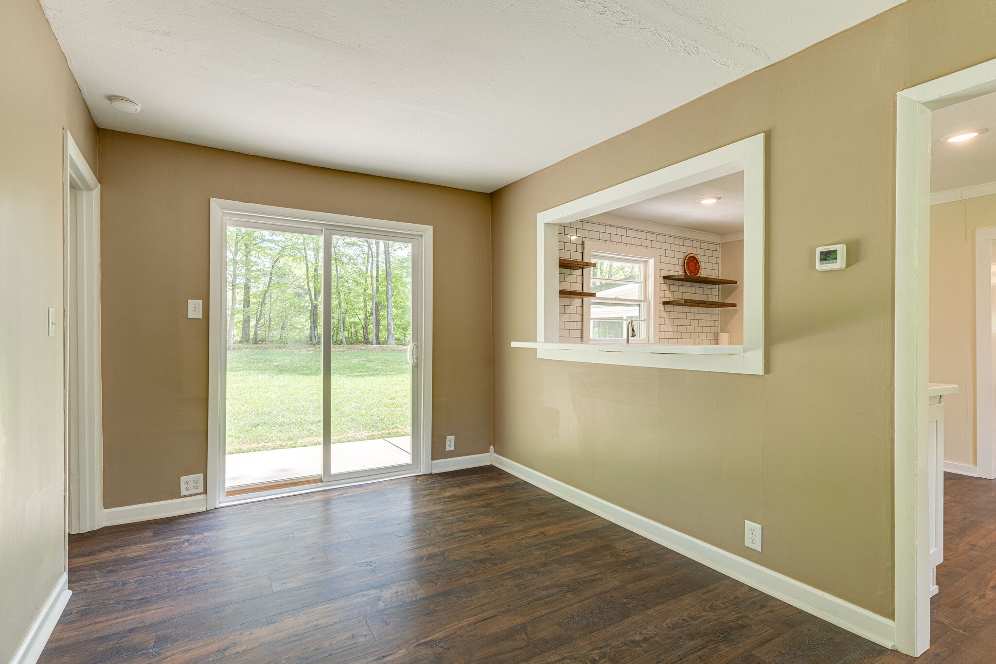 7357 Peaceful Acres Road Greenbrier, TN 37073 - Photo 5 of 27 a view of an empty room with wooden floor and a window