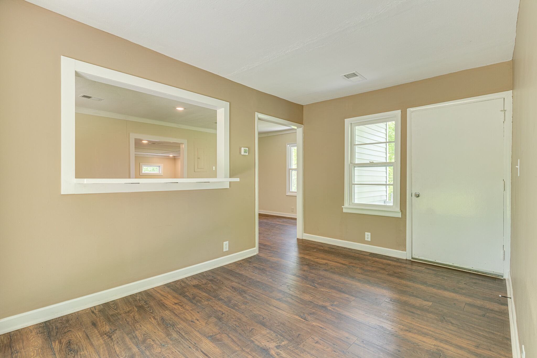 7357 Peaceful Acres Road Greenbrier, TN 37073 - Photo 6 of 27 an empty room with wooden floor and windows