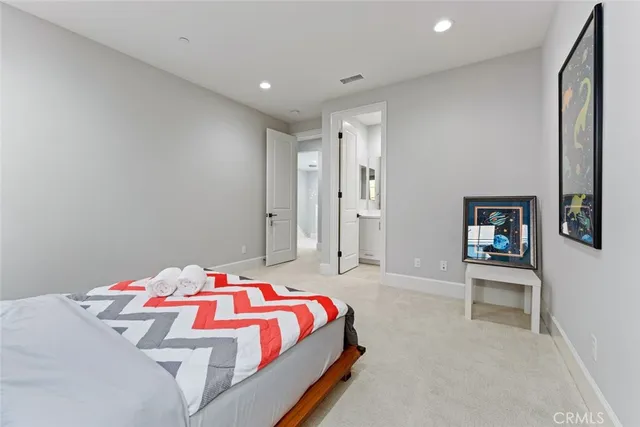 a bedroom with a bed and a lamp