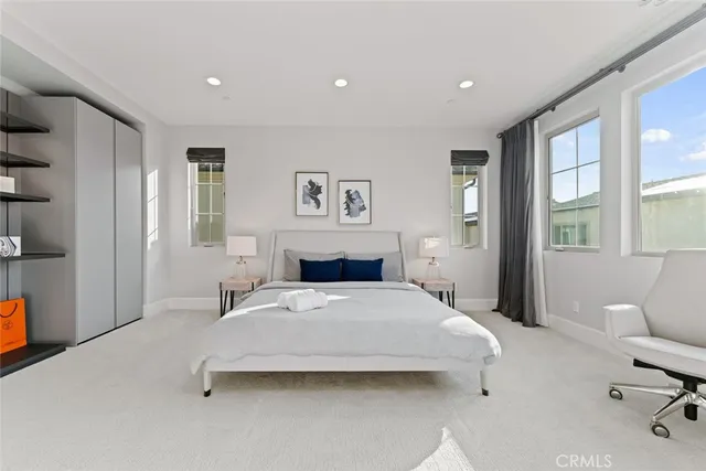 a bedroom with a bed and glass window