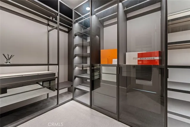 a large white kitchen with a large window and cabinets