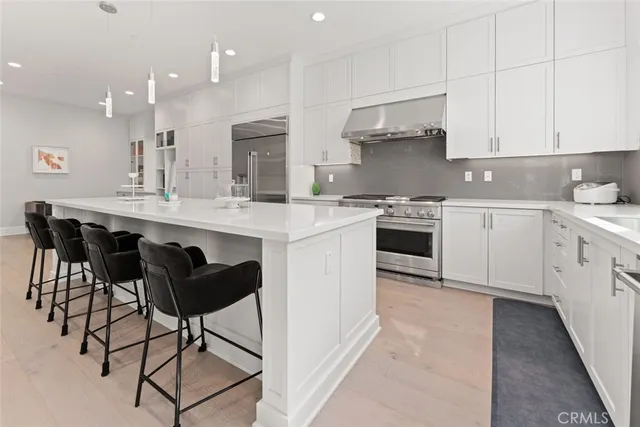 a kitchen with kitchen island granite countertop wooden cabinets and white appliances