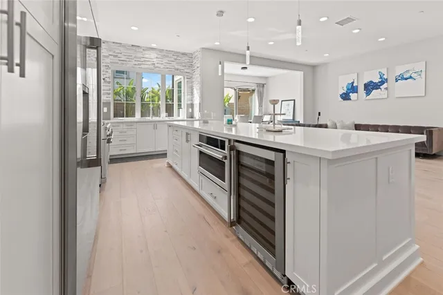 a kitchen with kitchen island a sink a stove and a refrigerator