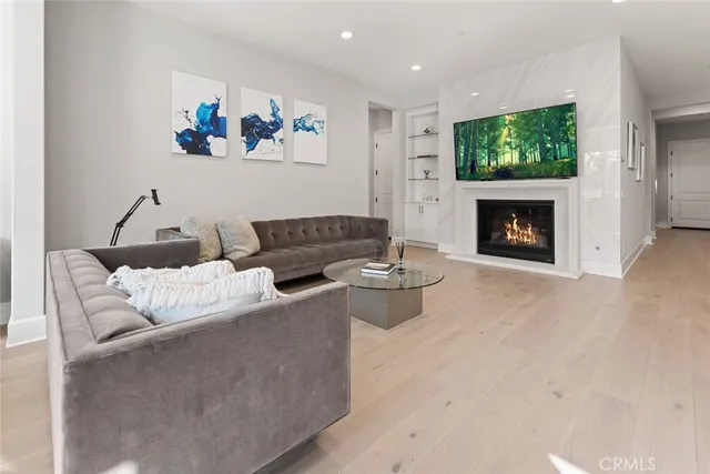 a living room with furniture a fireplace and a flat screen tv