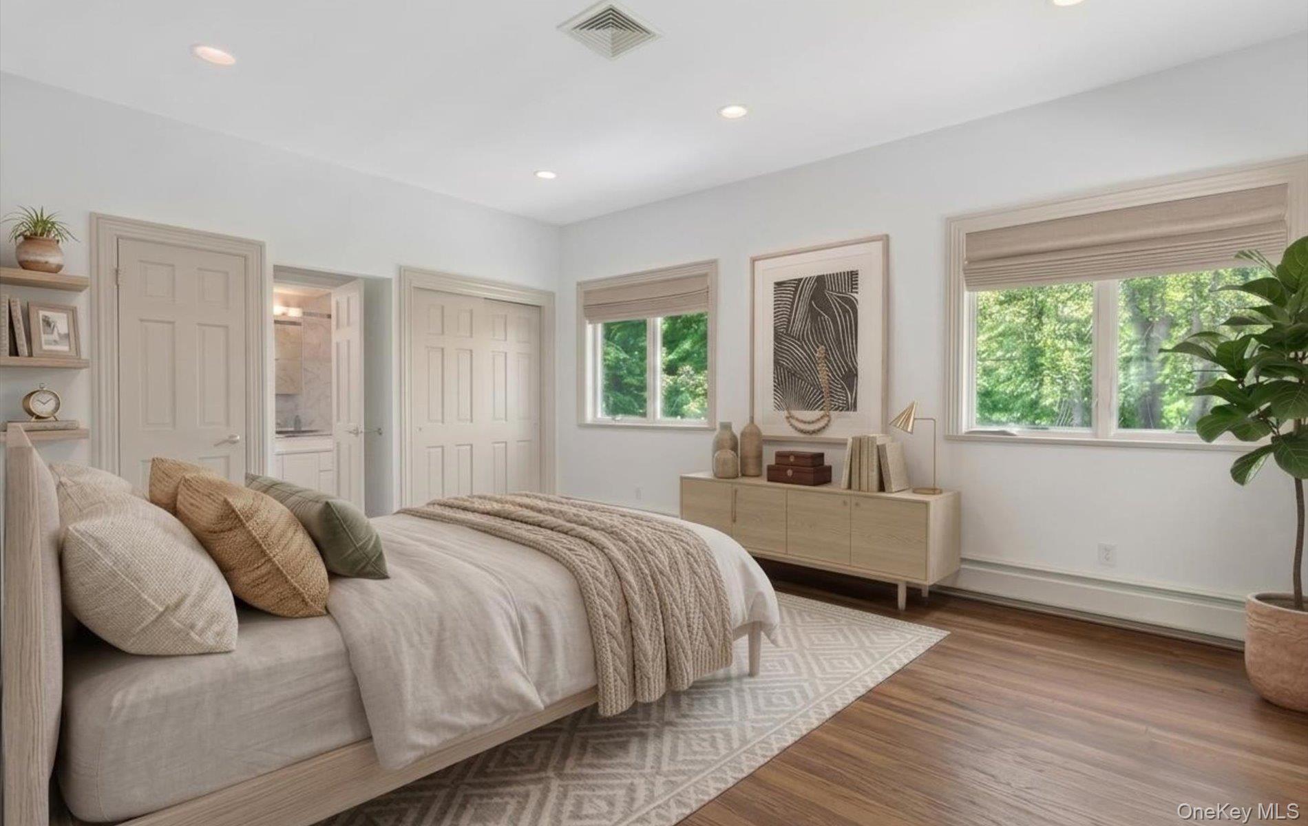 16 East Slope Road Bayville, NY 11709 - Photo 25 of 48 Staged bedroom with spacious room featuring wood-finish flooring, recessed lighting, and multiple windows with natural light