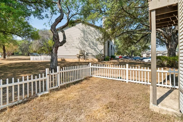 a view of a wooden fence and a trees