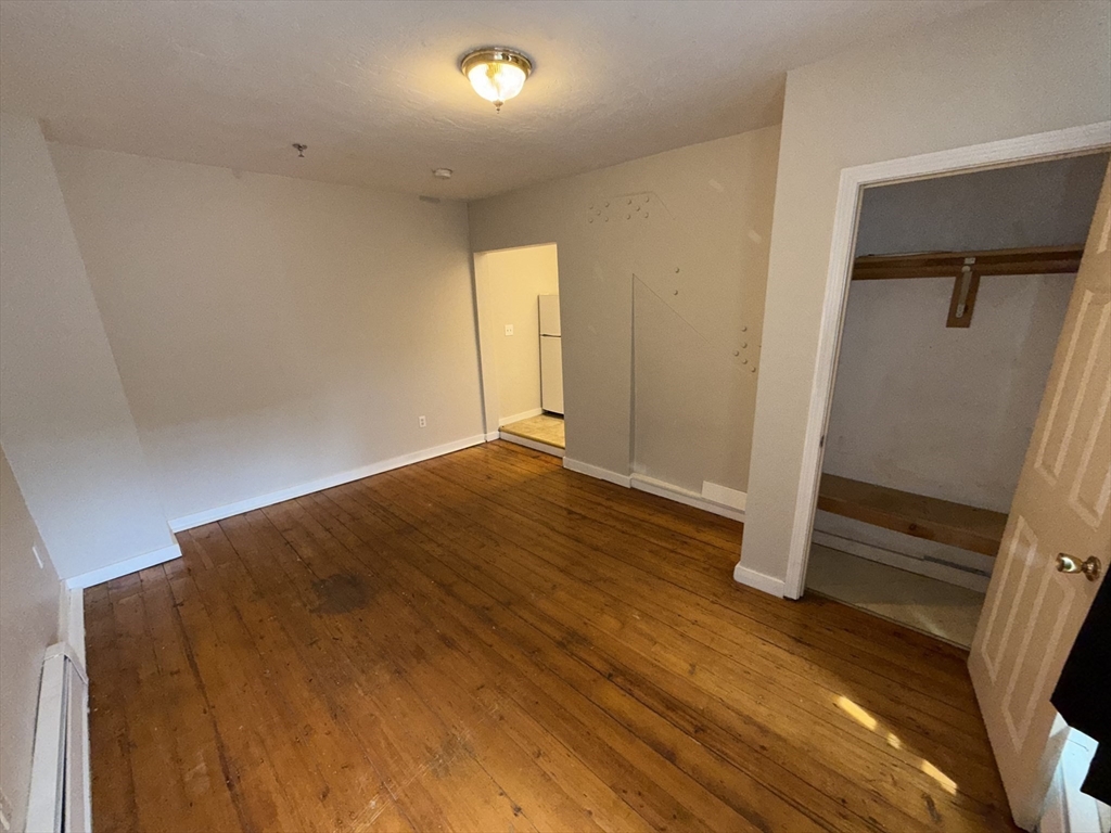 65 Main Street Hudson, MA 01749 - Photo 13 of 20 an empty room with wooden floor