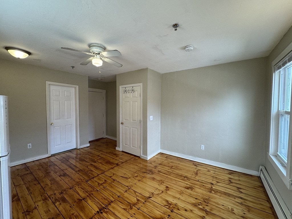 65 Main Street Hudson, MA 01749 - Photo 14 of 20 a bedroom with a bed and a window