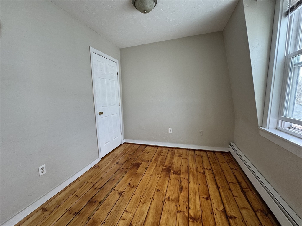 65 Main Street Hudson, MA 01749 - Photo 15 of 20 a view of a room with wooden floor and window