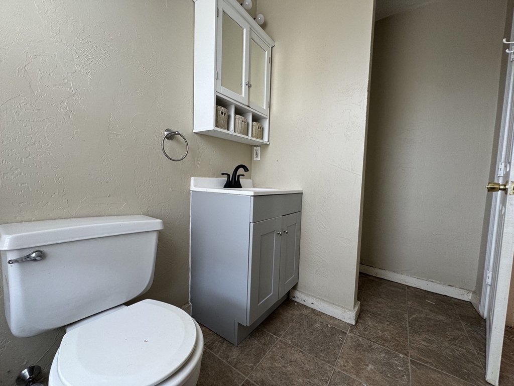 65 Main Street Hudson, MA 01749 - Photo 17 of 20 a white toilet sitting next to a bathroom sink