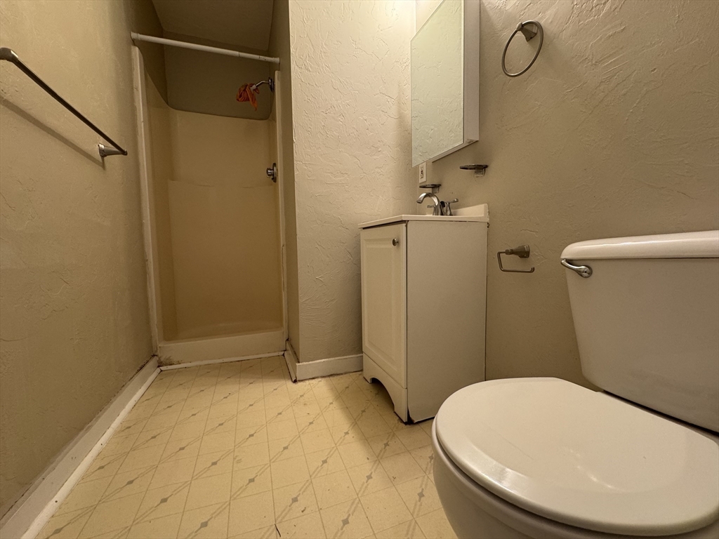 65 Main Street Hudson, MA 01749 - Photo 20 of 20 a bathroom with a sink and toilet