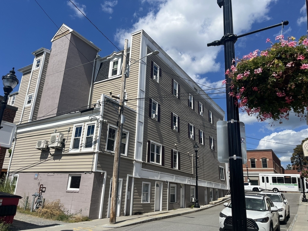 65 Main Street Hudson, MA 01749 - Photo 5 of 20 a front view of a building with street view