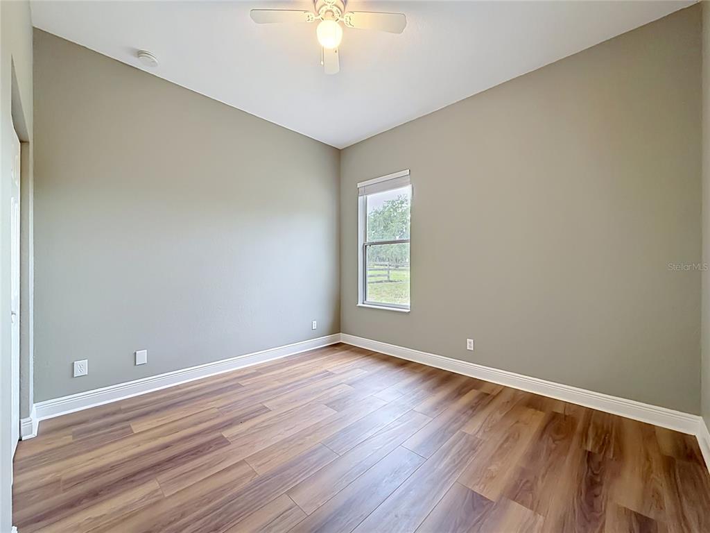28549 Shirley Shores Road Tavares, FL 32778 - Photo 36 of 65 wooden floor in an empty room with a window