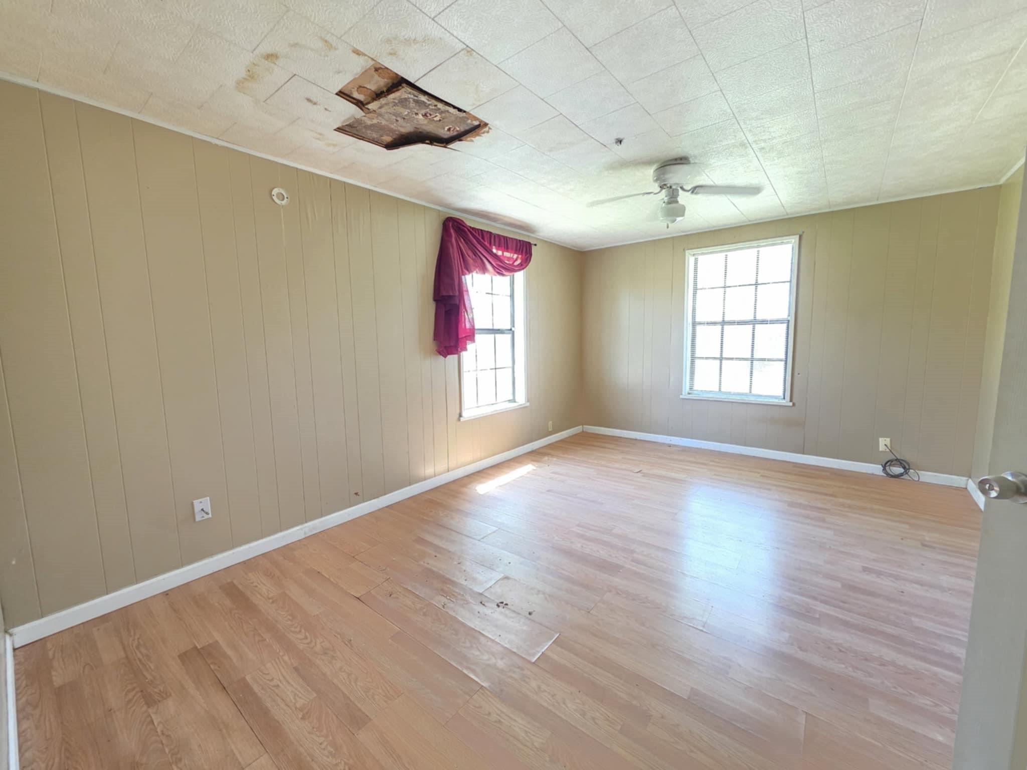 235 2nd Street Van Vleck, TX 77482 - Photo 16 of 23 an empty room with wooden floor and windows