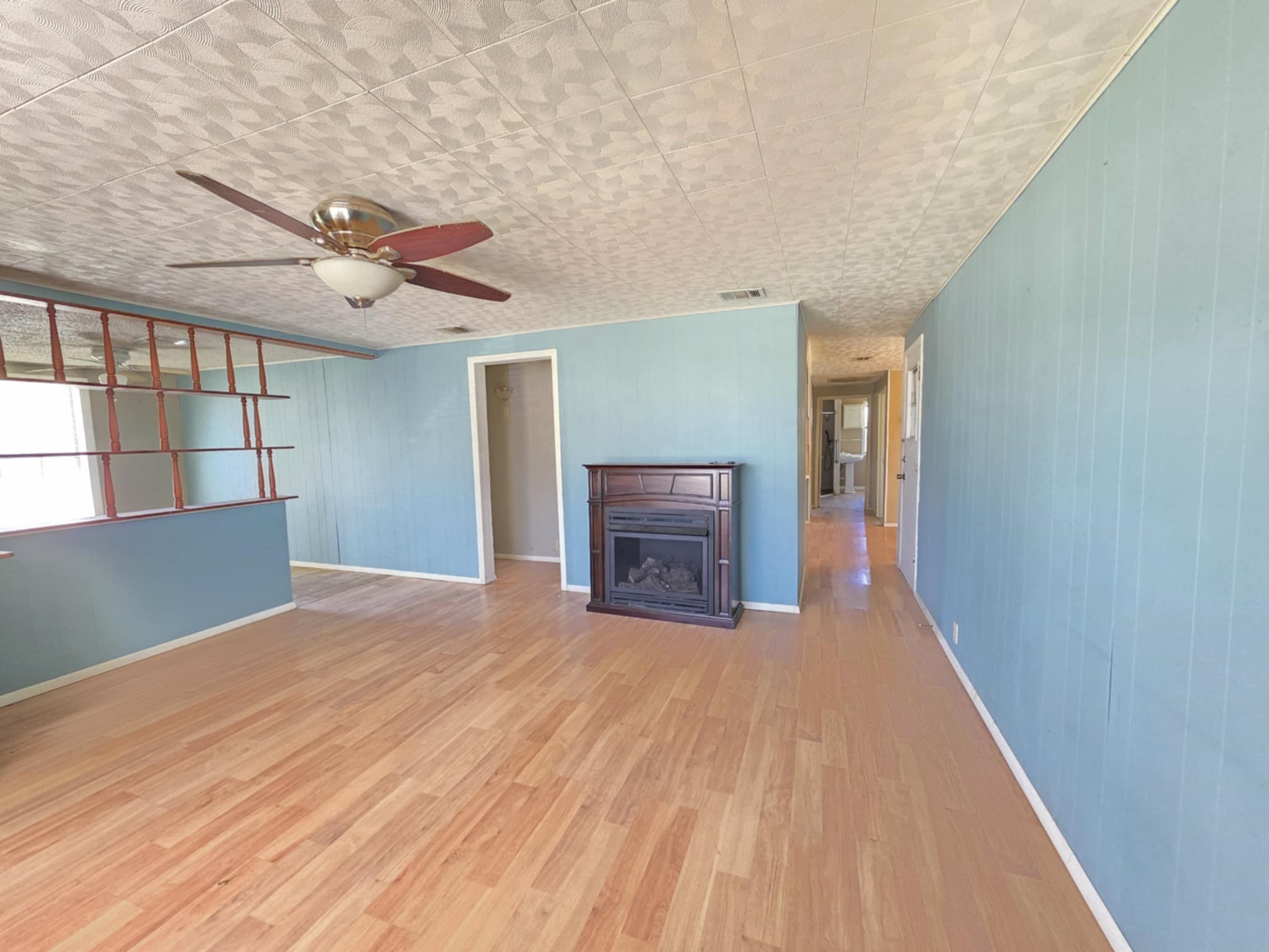 235 2nd Street Van Vleck, TX 77482 - Photo 2 of 23 a view of empty room with wooden floor and fan