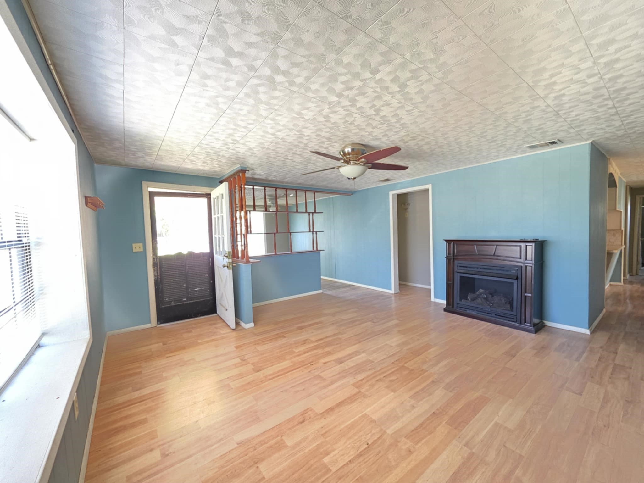 235 2nd Street Van Vleck, TX 77482 - Photo 4 of 23 a view of an empty room with window and wooden floor