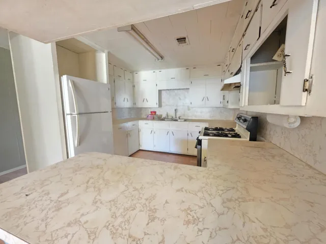 a kitchen with stainless steel appliances a refrigerator and a stove