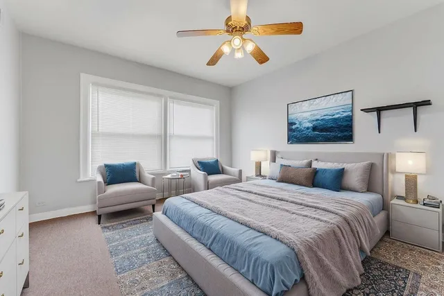 a bedroom with a bed a couch and a window