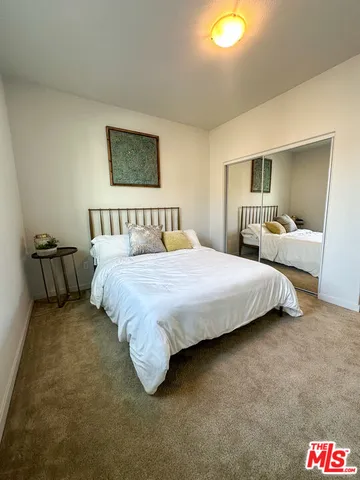 a bedroom with a bed and lamp