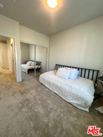 a spacious bedroom with a bed and couch