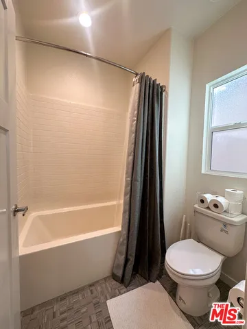 a bathroom with a toilet a sink and a bathtub