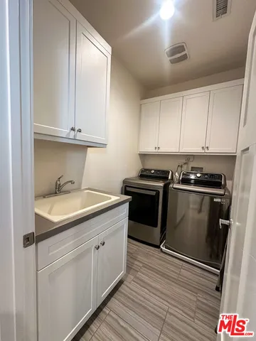 a kitchen with granite countertop white cabinets and stainless steel appliances