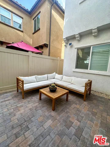 a backyard of a house with outdoor seating