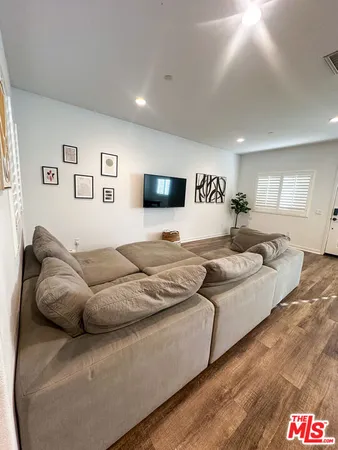 a large bedroom with a bed and a couch