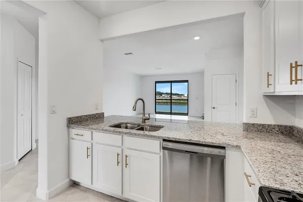 a kitchen with granite countertop kitchen island with white cabinets