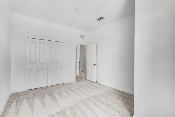 an empty room with gym equipment and a large window
