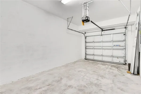 an empty room with sliding glass door and chandelier fan