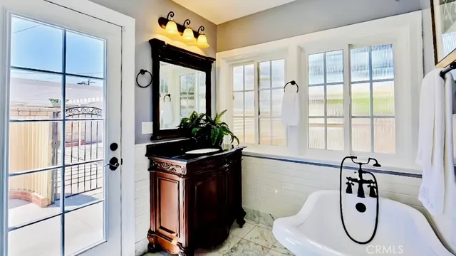 a bathroom with a granite countertop sink a mirror and shower