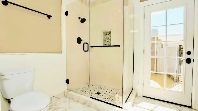 a bathroom with a shower and toilet
