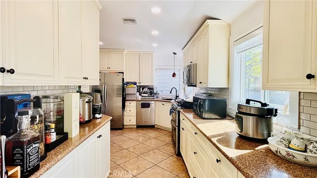a kitchen with a sink appliances and cabinets