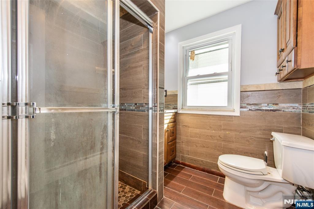 86 Watsessing Avenue, Unit 2 Bloomfield, NJ 07003 - Photo 11 of 23 a bathroom with a toilet and a shower