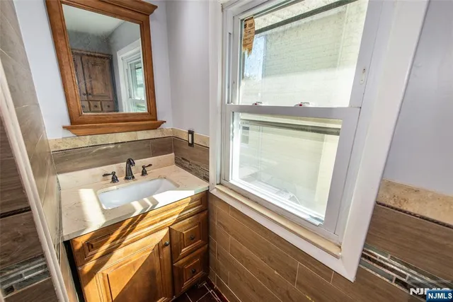 a bathroom with a sink a mirror and a bathtub