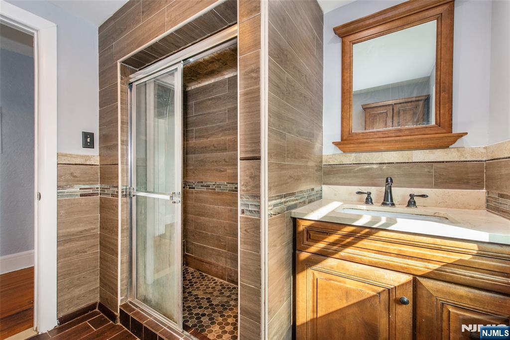 86 Watsessing Avenue, Unit 2 Bloomfield, NJ 07003 - Photo 14 of 23 a bathroom with a sink and a shower