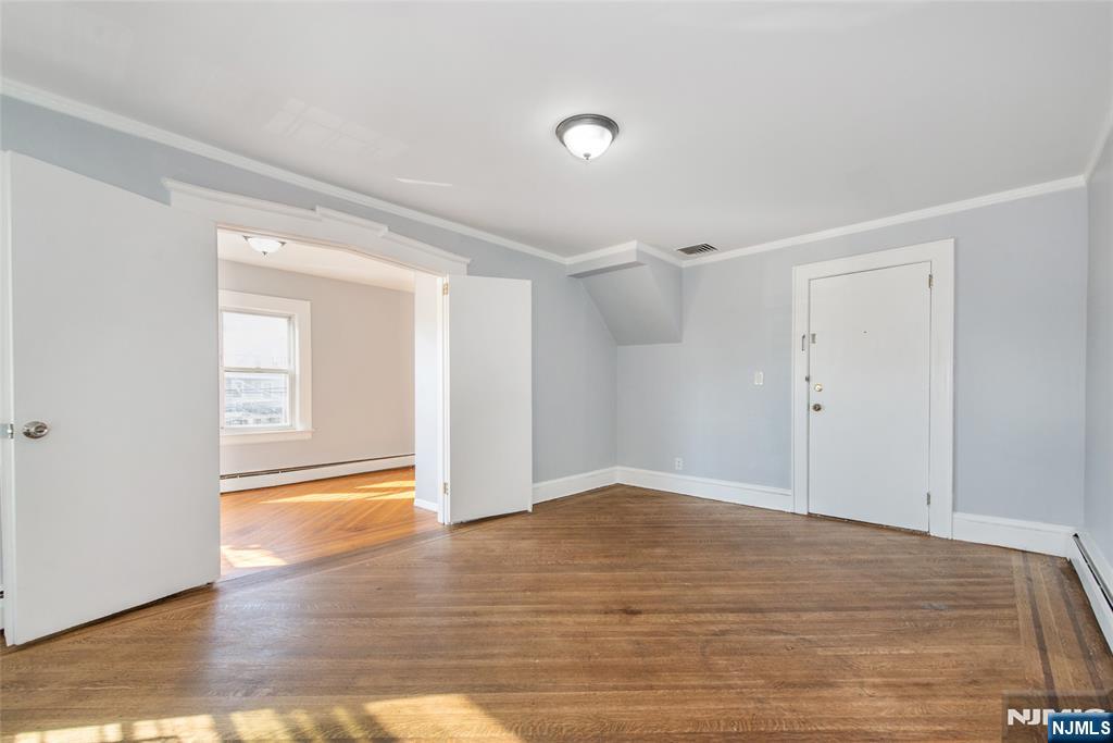 86 Watsessing Avenue, Unit 2 Bloomfield, NJ 07003 - Photo 16 of 23 a view of an empty room and wooden floor