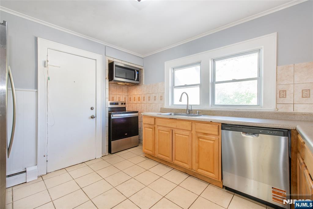86 Watsessing Avenue, Unit 2 Bloomfield, NJ 07003 - Photo 9 of 23 a large kitchen with a window and stainless steel appliances