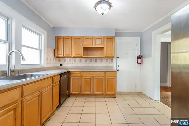 a kitchen with stainless steel appliances granite countertop a sink and a refrigerator